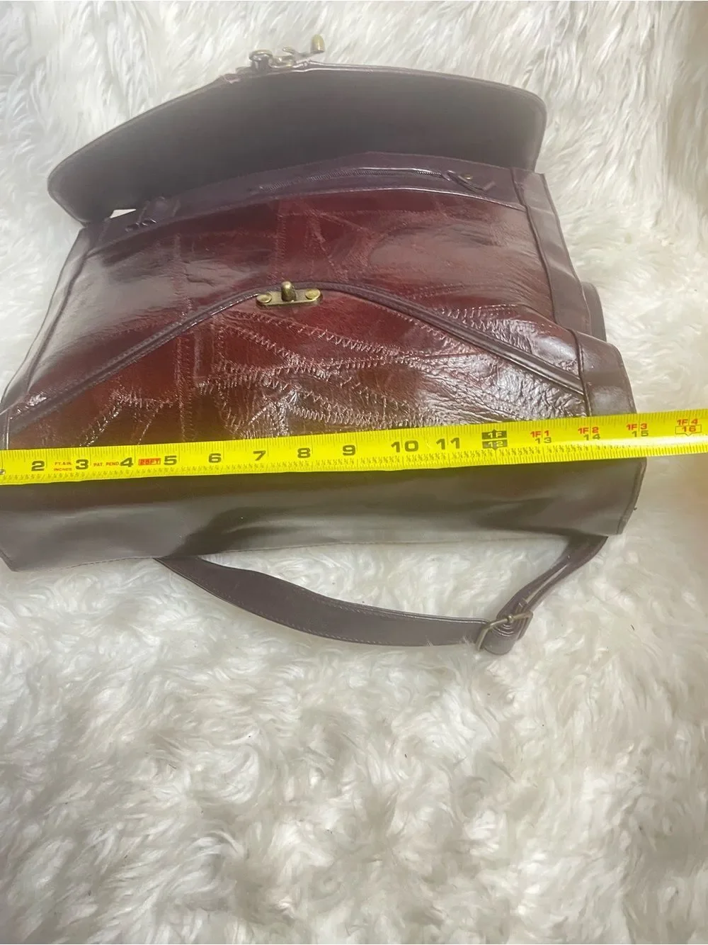 M.C textured leather patchwork like stitched accent burgundy leather bag .